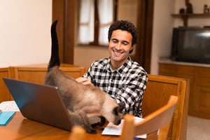 Man-working-at-home-with-his-cat