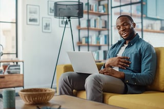 Man-working-from-home-on-yellow-sofa