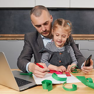 Man-works-at-home-with-daughter