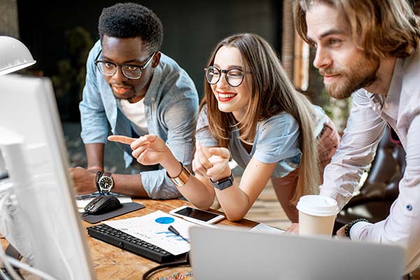 Team looking at a moniter in an office