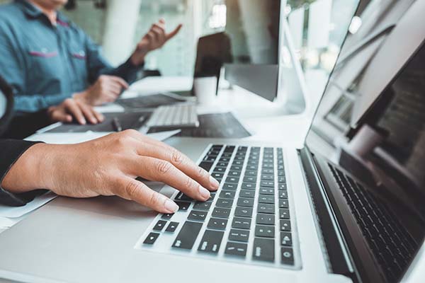 close up of a laptop with person typing